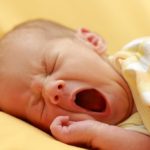 a newborn baby yawning