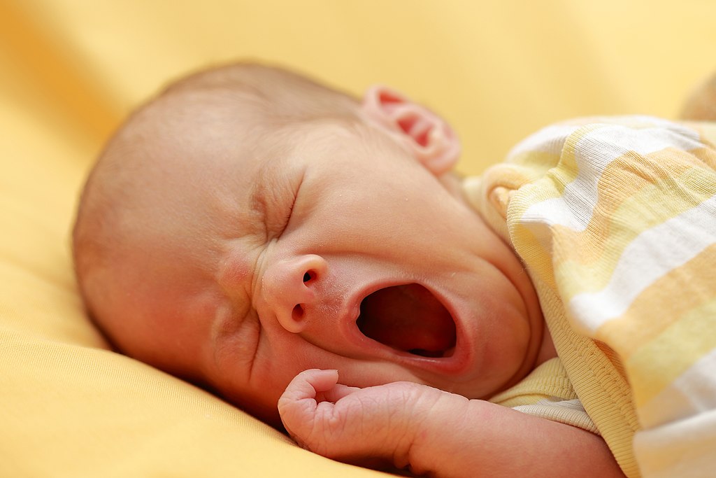 a newborn baby yawning